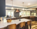 beautiful kitchen remodel with dark custom cabinetry and light countertops