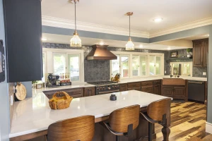 beautiful kitchen remodel with dark custom cabinetry and light countertops