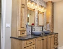 bathroom vanity with double vessel sinks and custom backsplash