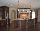 kitchen renovation featuring a unique built-in range with custom stonework