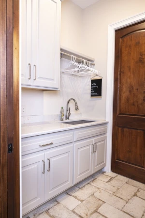 laundry room with custom flooring and utility sink